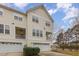 Well-maintained townhome featuring a private balcony, two-car garage, and manicured shrubs at 4308 Brynwood Ave, Durham, NC 27713