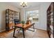 Bright home office features wood floors, built-in shelving, and a view to the outdoors at 4308 Brynwood Ave, Durham, NC 27713