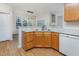 Well-lit kitchen with wooden cabinets, white countertops, and modern appliances at 4308 Brynwood Ave, Durham, NC 27713