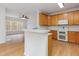 Bright kitchen with wood floors, white countertops, and views into a living area at 4308 Brynwood Ave, Durham, NC 27713
