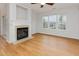Cozy living room with fireplace and an abundance of natural light from large windows at 4308 Brynwood Ave, Durham, NC 27713