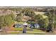 Aerial view of the home and property featuring multiple outbuildings and large trees at 4316 Old Faison Rd, Knightdale, NC 27545