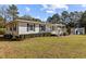An angled view of the home, showcasing its well-manicured lawn, attractive siding, and inviting front porch at 4316 Old Faison Rd, Knightdale, NC 27545