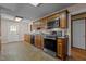 Kitchen featuring tiled floor, oak cabinets, and stainless steel oven against neutral-colored walls at 4316 Old Faison Rd, Knightdale, NC 27545