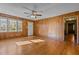 Spacious living room with wood paneling, hardwood floors, and a ceiling fan for added comfort at 4316 Old Faison Rd, Knightdale, NC 27545