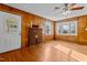 Inviting living room features wood paneling, brick fireplace, and bright windows offering natural light at 4316 Old Faison Rd, Knightdale, NC 27545