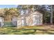 Exterior view of metal outbuilding with a roll up door and adjacent gate on the property at 4316 Old Faison Rd, Knightdale, NC 27545