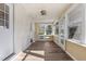 Sunroom featuring wood floors and abundant natural light, with multiple windows and access to exterior doors at 4316 Old Faison Rd, Knightdale, NC 27545