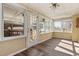 Bright sunroom featuring hardwood floors, multiple windows offering natural light, and access to outdoor spaces at 4316 Old Faison Rd, Knightdale, NC 27545
