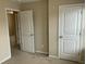 Bedroom with two white doors and neutral carpet and paint at 4469 Middletown Dr, Wake Forest, NC 27587