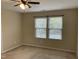 Neutral bedroom with carpet, blinds, natural light from two windows, and a ceiling fan at 4469 Middletown Dr, Wake Forest, NC 27587