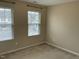 Bedroom with two windows and neutral carpet and paint at 4469 Middletown Dr, Wake Forest, NC 27587