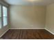 Bedroom with neutral walls, wood floors, and a large window with horizontal blinds at 4469 Middletown Dr, Wake Forest, NC 27587