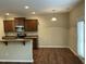 A bright dining area with wooden cabinets, stainless steel appliances, and a door to the backyard at 4469 Middletown Dr, Wake Forest, NC 27587