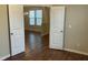 View into bright dining area featuring hardwood floors, modern chandelier, and natural light from windows at 4469 Middletown Dr, Wake Forest, NC 27587