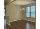 Bright dining area features hardwood floors, modern chandelier, and natural light from windows at 4469 Middletown Dr, Wake Forest, NC 27587