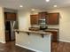 Bright kitchen features stainless steel appliances, breakfast bar, and wooden cabinets at 4469 Middletown Dr, Wake Forest, NC 27587