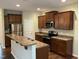 Well-lit kitchen features stainless steel appliances, a breakfast bar, and plentiful wood cabinetry at 4469 Middletown Dr, Wake Forest, NC 27587