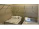 Bright laundry area with washer, dryer, and wire shelving for storage at 4469 Middletown Dr, Wake Forest, NC 27587