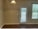 Room with neutral walls, wood floors, and a door and windows with horizontal blinds at 4469 Middletown Dr, Wake Forest, NC 27587