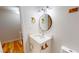 Stylish bathroom showcasing a vanity with gold fixtures, a round mirror, and attractive lighting at 4604 Sweet Melody Ln, Knightdale, NC 27545
