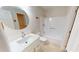 A well-lit bathroom featuring a modern vanity, quartz countertops, and a tub-shower at 4604 Sweet Melody Ln, Knightdale, NC 27545