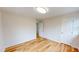 Cozy bedroom with hardwood floors, neutral paint, and ample natural light from a front window at 4604 Sweet Melody Ln, Knightdale, NC 27545