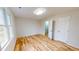 Sunlit bedroom showcasing hardwood floors and neutral paint at 4604 Sweet Melody Ln, Knightdale, NC 27545