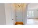 Bright entryway showcasing hardwood floors, neutral walls, and a modern chandelier at 4604 Sweet Melody Ln, Knightdale, NC 27545