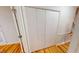 View of a hallway featuring hardwood floors, white trim and doors, and a closet at 4604 Sweet Melody Ln, Knightdale, NC 27545