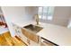 Updated kitchen featuring a large stainless steel sink, marble countertops, and gold hardware at 4604 Sweet Melody Ln, Knightdale, NC 27545