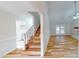 Open concept living space with hardwood floors, a staircase and view into the dining area at 4604 Sweet Melody Ln, Knightdale, NC 27545