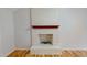 Living room with a white painted brick fireplace and mantel over hardwood floors at 4604 Sweet Melody Ln, Knightdale, NC 27545