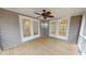 Charming screened porch featuring gray siding, a ceiling fan, and double French doors at 4604 Sweet Melody Ln, Knightdale, NC 27545
