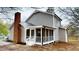 Exterior view of a home with a screened-in porch featuring white railings and brick chimney at 4604 Sweet Melody Ln, Knightdale, NC 27545