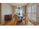 Dining room with hardwood floors, chandelier lighting and large window view at 4709 Delta Lake Dr, Raleigh, NC 27612