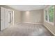 Neutral colored bedroom with beige carpet and trim, and a door to the attached bath at 502 Forest Court, Carrboro, NC 27510