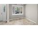 Bright dining area with a large window, tile floor and door to the outside at 502 Forest Court, Carrboro, NC 27510
