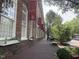 Carr Mill building exterior featuring brick facade, large windows, planters, and sidewalk at 502 Forest Court, Carrboro, NC 27510
