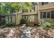 Charming exterior of townhome showcasing the entrance with a stone pathway and lush landscaping at 502 Forest Court, Carrboro, NC 27510