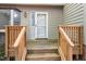 A view of the front door with wood steps and railings leading up to the front porch at 502 Forest Court, Carrboro, NC 27510