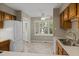 Bright kitchen has a window, tile floors, and white appliances at 502 Forest Court, Carrboro, NC 27510