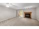 Carpeted living room featuring a fireplace and a double glass patio door for natural light at 502 Forest Court, Carrboro, NC 27510