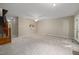 Large living room featuring neutral walls, carpet flooring, and a glimpse into the kitchen at 502 Forest Court, Carrboro, NC 27510