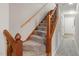 Carpeted staircase with wooden banister leads to the next level in this home at 502 Forest Court, Carrboro, NC 27510