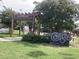 View of the Carborro Town Commons with lush greenery, a covered structure, and a sign at 502 Forest Court, Carrboro, NC 27510