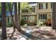 Exterior view of a charming two-story townhouse with a wood porch and front yard at 502 Forest Court, Carrboro, NC 27510