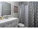 Bathroom with white vanity, white toilet, and gray shower curtain at 543 Pine Ridge Place, Raleigh, NC 27609