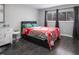 Bedroom with gray walls, wood floors, two windows with blinds and black curtains, and a gray platform bed at 543 Pine Ridge Place, Raleigh, NC 27609