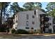 A multistory apartment complex exterior with a light beige facade, dark window frames, and dark brown wood balconies at 543 Pine Ridge Place, Raleigh, NC 27609